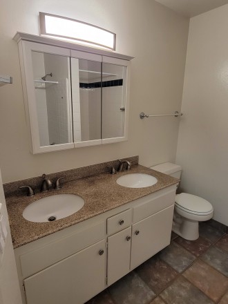 Bathroom with 2 sinks and 2 showers